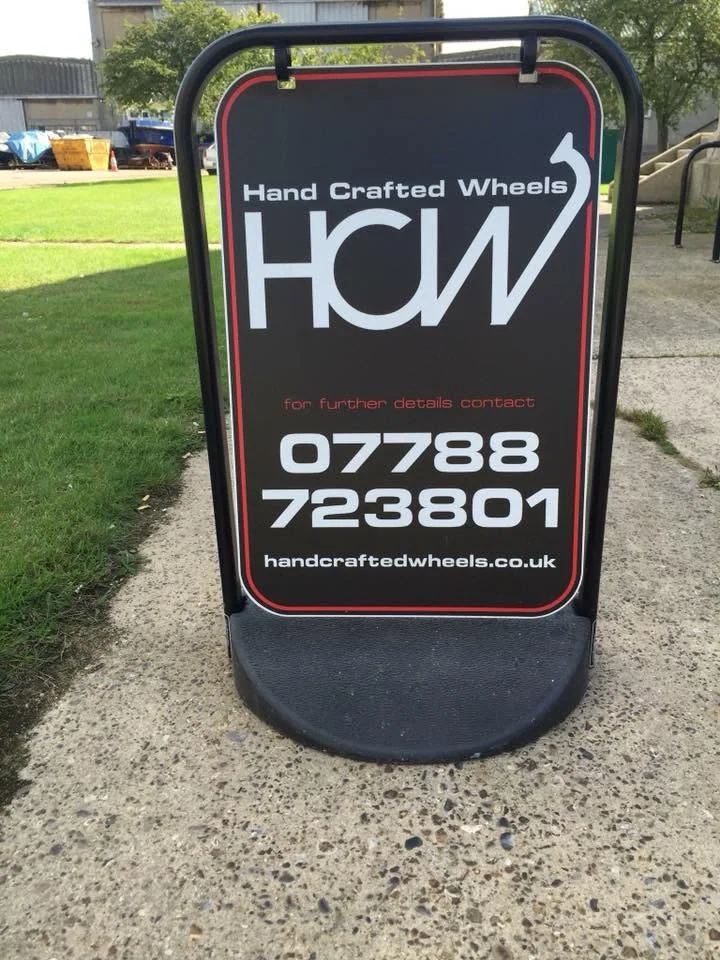 Hand Crafted Wheels outdoor sign displaying the business name and telephone number